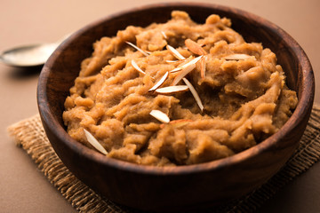 Wheat flour Halwa or Shira or porridge /  Atte ka Halva, Popular healthy dessert or breakfast menu from India. served in a bowl or plate. selective focus