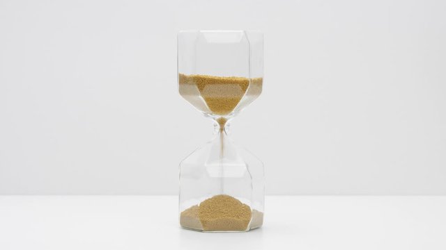 Closeup of a sand clock in the middle of the frame