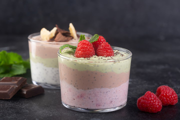 Chia seed pudding with three flavors, cocoa, matcha and strawberry with yoghurt, chocolate and mint...