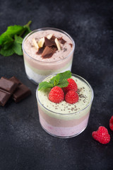 Chia seed pudding with three flavors, cocoa, matcha and strawberry with yoghurt, chocolate and mint leaves. Close up