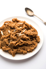 Wheat flour Halwa or Shira or porridge /  Atte ka Halva, Popular healthy dessert or breakfast menu from India. served in a bowl or plate. selective focus