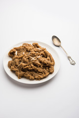 Wheat flour Halwa or Shira or porridge /  Atte ka Halva, Popular healthy dessert or breakfast menu from India. served in a bowl or plate. selective focus
