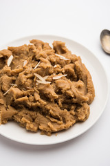 Wheat flour Halwa or Shira or porridge /  Atte ka Halva, Popular healthy dessert or breakfast menu from India. served in a bowl or plate. selective focus