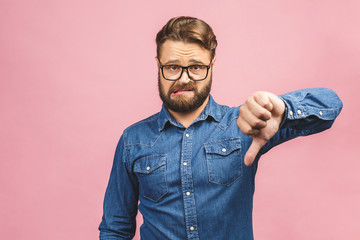 Stylish fashionable male poses indoors against pink background, assess project, shows sign of...