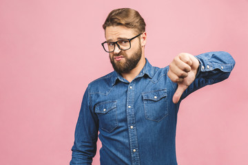 Stylish fashionable male poses indoors against pink background, assess project, shows sign of...