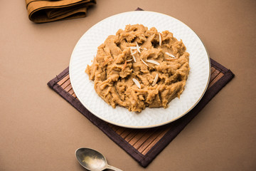 Wheat flour Halwa or Shira or porridge /  Atte ka Halva, Popular healthy dessert or breakfast menu from India. served in a bowl or plate. selective focus