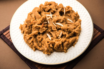 Wheat flour Halwa or Shira or porridge /  Atte ka Halva, Popular healthy dessert or breakfast menu from India. served in a bowl or plate. selective focus