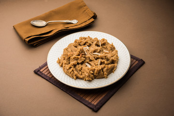 Wheat flour Halwa or Shira or porridge /  Atte ka Halva, Popular healthy dessert or breakfast menu from India. served in a bowl or plate. selective focus