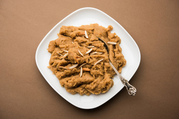Wheat flour Halwa or Shira or porridge /  Atte ka Halva, Popular healthy dessert or breakfast menu from India. served in a bowl or plate. selective focus