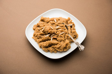 Wheat flour Halwa or Shira or porridge /  Atte ka Halva, Popular healthy dessert or breakfast menu from India. served in a bowl or plate. selective focus