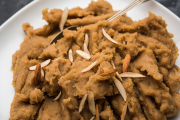 Wheat flour Halwa or Shira or porridge /  Atte ka Halva, Popular healthy dessert or breakfast menu from India. served in a bowl or plate. selective focus