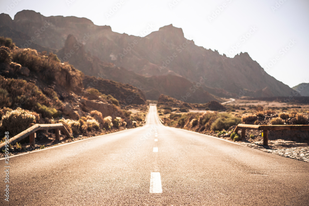 Wall mural beautiful and scenic long way road with focus on foreground - defocused background and travel destin