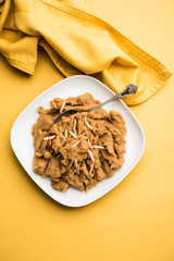 Wheat flour Halwa or Shira or porridge /  Atte ka Halva, Popular healthy dessert or breakfast menu from India. served in a bowl or plate. selective focus