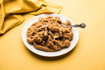 Wheat flour Halwa or Shira or porridge /  Atte ka Halva, Popular healthy dessert or breakfast menu from India. served in a bowl or plate. selective focus