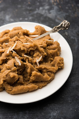 Wheat flour Halwa or Shira or porridge /  Atte ka Halva, Popular healthy dessert or breakfast menu from India. served in a bowl or plate. selective focus