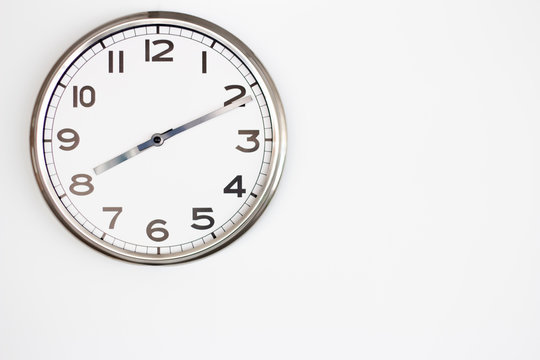 White Clock on White wall with copy-space.