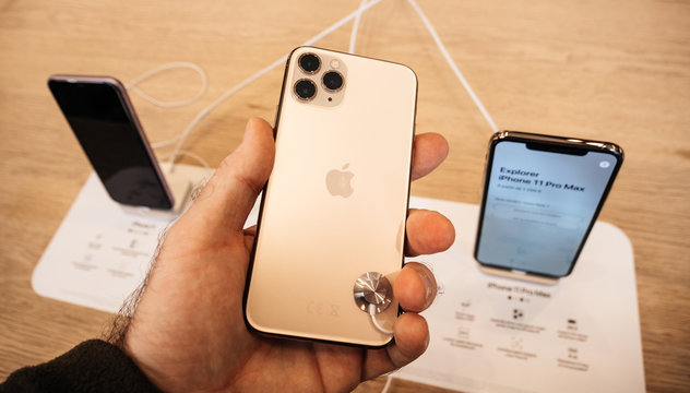 Paris, France - Sep 20, 2019: Man Looking At The Matte Finish Of The New IPhone 11 Pro Displayed In Apple Store As The Smartphone By Apple Computers Goes On Sale