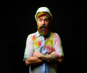 Builder, craftsman. Surprised painter with arms crossed. Handsome bearded painter in splattered shirt. Painter in white hard hat. Construction manager on site. Professional engineer in safety helmet.
