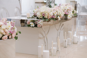 Side view on the luxury table of the groom and bride of rectangular shape with a mirror part