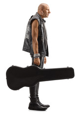 Rock star standing with a guitar in a case