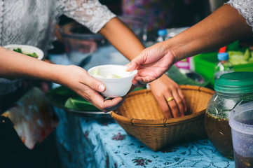 Volunteers serving food for poor people : concept of free food serving