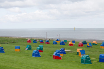 Colorful wooden beach chairs at the Dike of the North Sea in Otterndorf, Germany