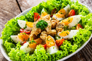 Boiled eggs with roast chicken fillet and vegetables