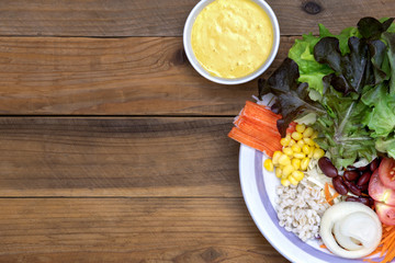 salad with mayonnaise on wood background with copy space