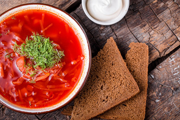 Ukrainian traditional dish borsch on a wooden board