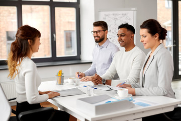 new job, hiring and employment concept - international team of recruiters having interview with asian female employee at office