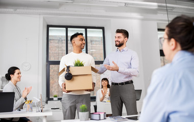 business, new job and corporate concept - indian male employee with personal stuff meeting colleagues at office