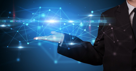 Handsome person holding hologram screen displaying modern cloud based web system technology