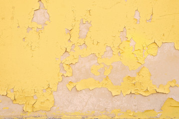 Texture of cracked yellow wall background. Old cracked background.