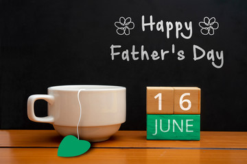 Text of happy father day with coffee cup on wooden background