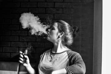 Vape teenager with  problem skin. Portrait of young cute girl smoking an electronic cigarette in...