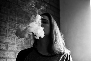 Vape teenager with  problem skin. Portrait of young cute girl smoking an electronic cigarette in...