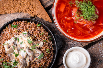 borsch and buckwheat porridge on a wooden board