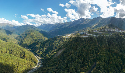 ski resort near the gorge and the river among the high Caucasus mountains (South of Russia) on a sunny summer morning