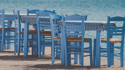 Fototapeta na wymiar Open cafe outdoor restaurant in Greece on sea shore