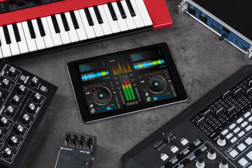 Mixing music on tablet with electronic music instruments concept