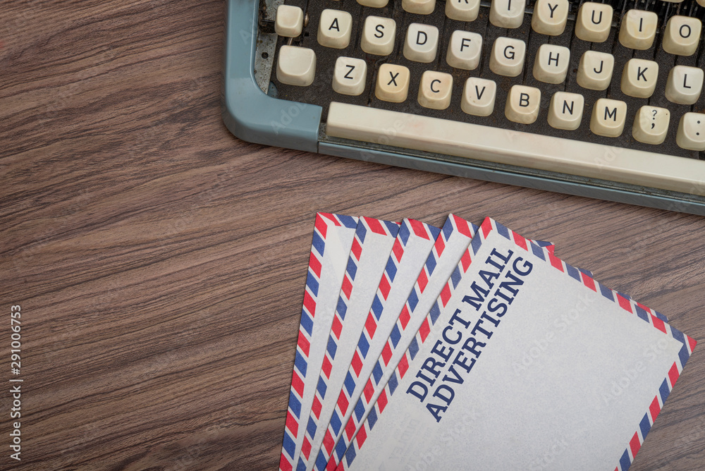 Fototapete manual typewriter with post card and envelopes on wooden background top view