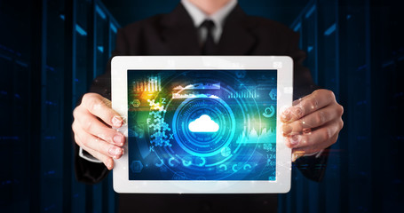 Hand holding tablet with cloud technology and dark concept