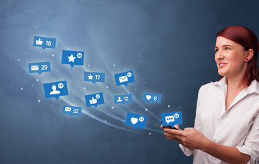 Young person using phone with flying social media icons around