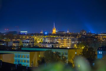 Night urban landscape, city, Szczecin, Poland, clouds, top-view, blocks, churches embedded between buildings, city center, lights