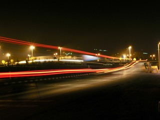 Fototapeta na wymiar long exposure photography of road while cars are passing and leaving rays of lights