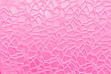 Ornament on the background of a pink wall. texture of grid the background of a smooth pink wall.