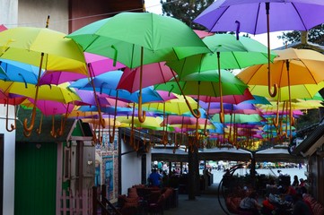 Fototapeta na wymiar umbrellas of different colors on the street