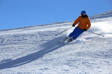 Sporty skier riding the slope 