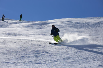 Sporty skier riding the slope 