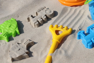 Children's toys for playing in the sand. Children's play on the beach on a summer sunny day.